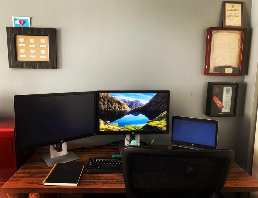 office desk with multiple screen set up