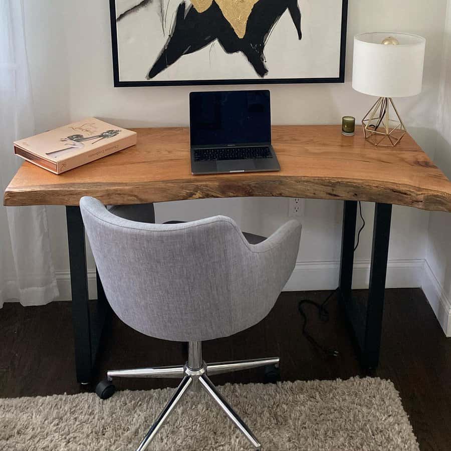 Live edge desk in a chic home office with abstract art