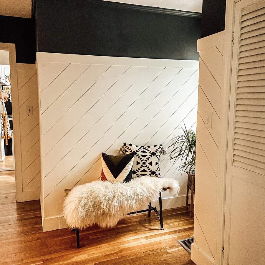 Corner nook with diagonal shiplap and plush bench