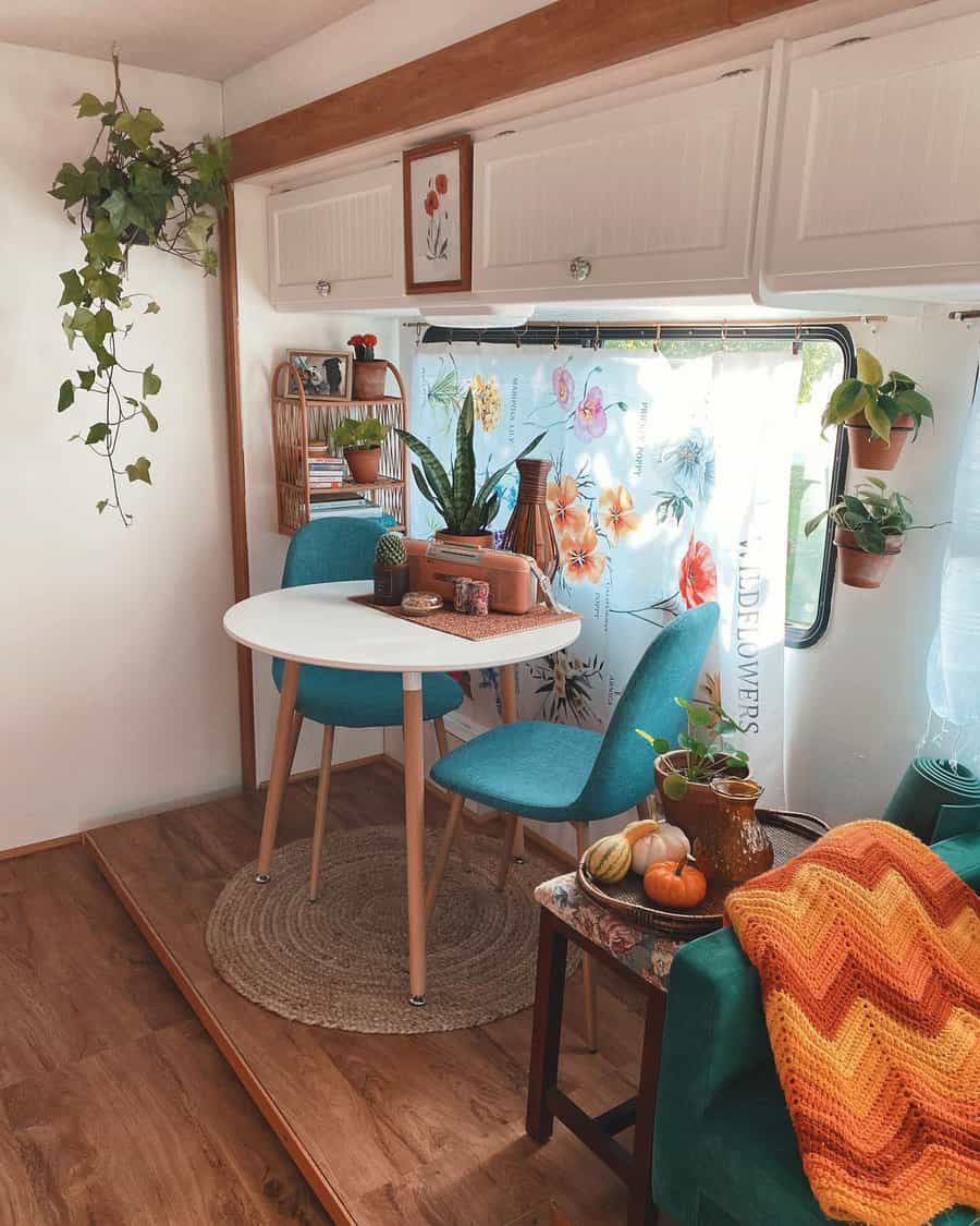 Colorful RV dining area with floral curtain and vibrant decor