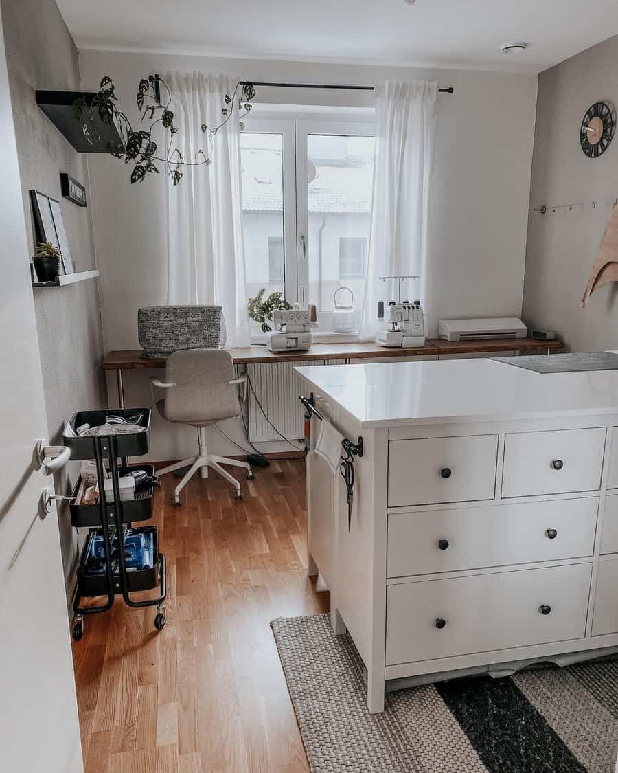 Chic craft room with white furniture and natural light