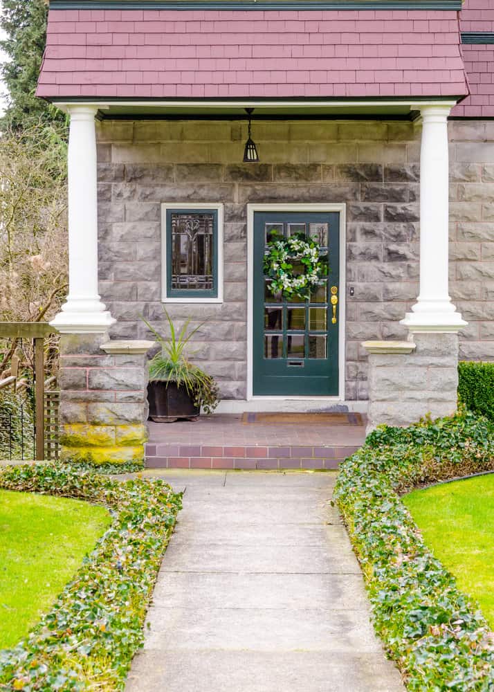 Historic home entrance with ivy-bordered pathway