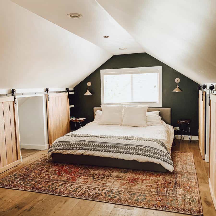 Cozy attic bedroom with built-in sliding barn door storage, a modern bed, soft lighting, and a warm, rustic rug for a stylish touch.