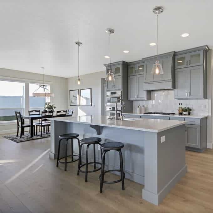 Airy kitchen with island seating and pendant lights