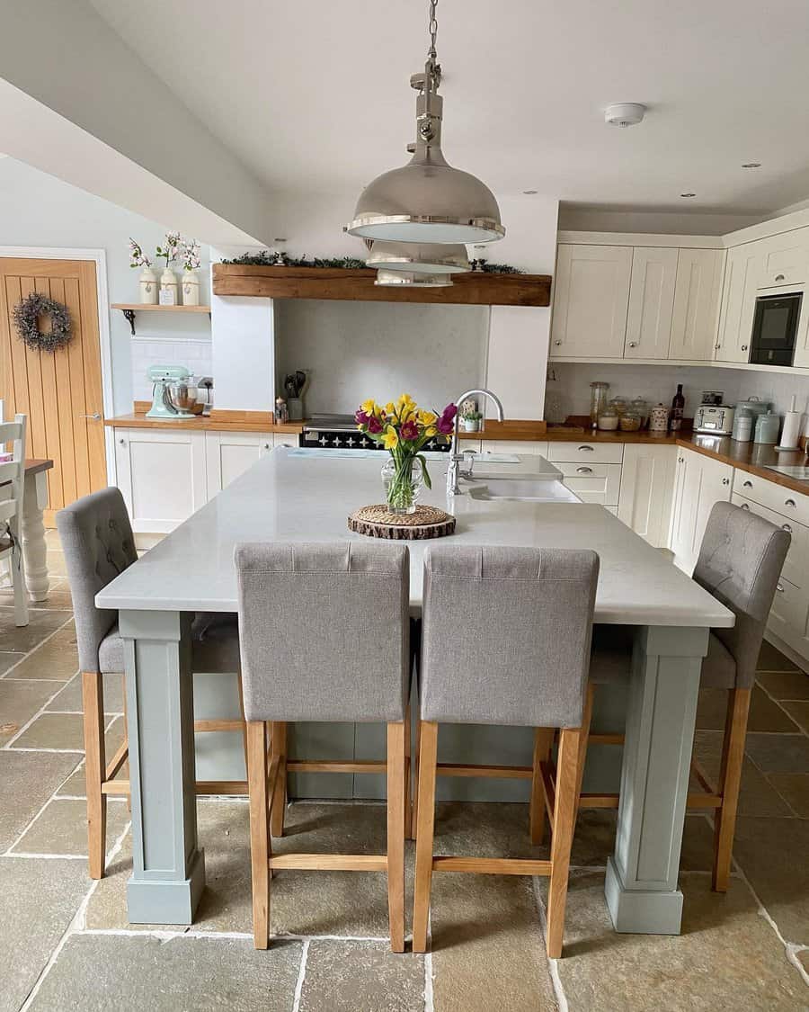 Cozy kitchen with grey chairs and large pendant light