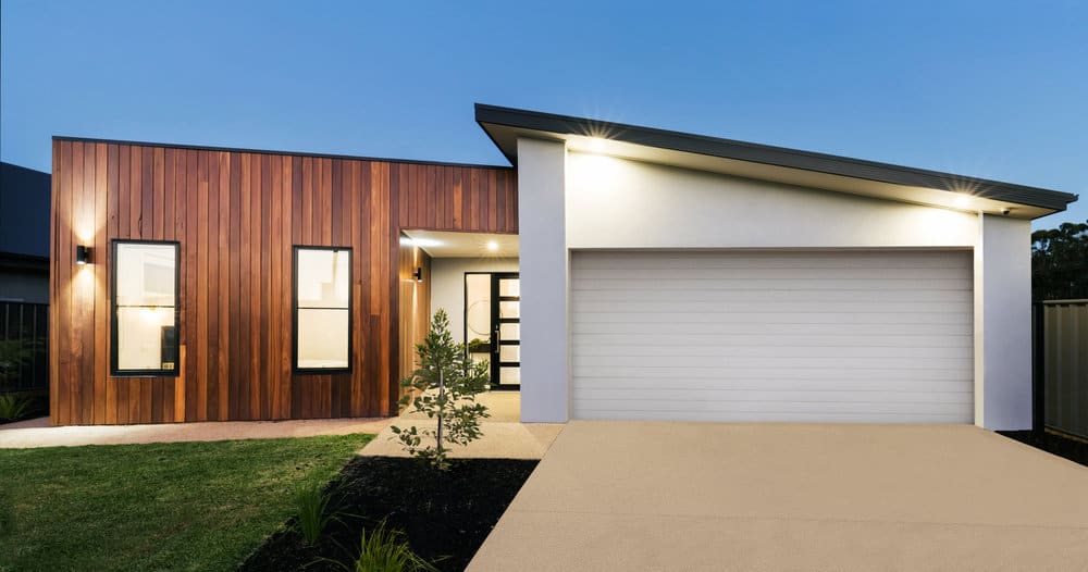 Modern home facade with garage and exterior lights