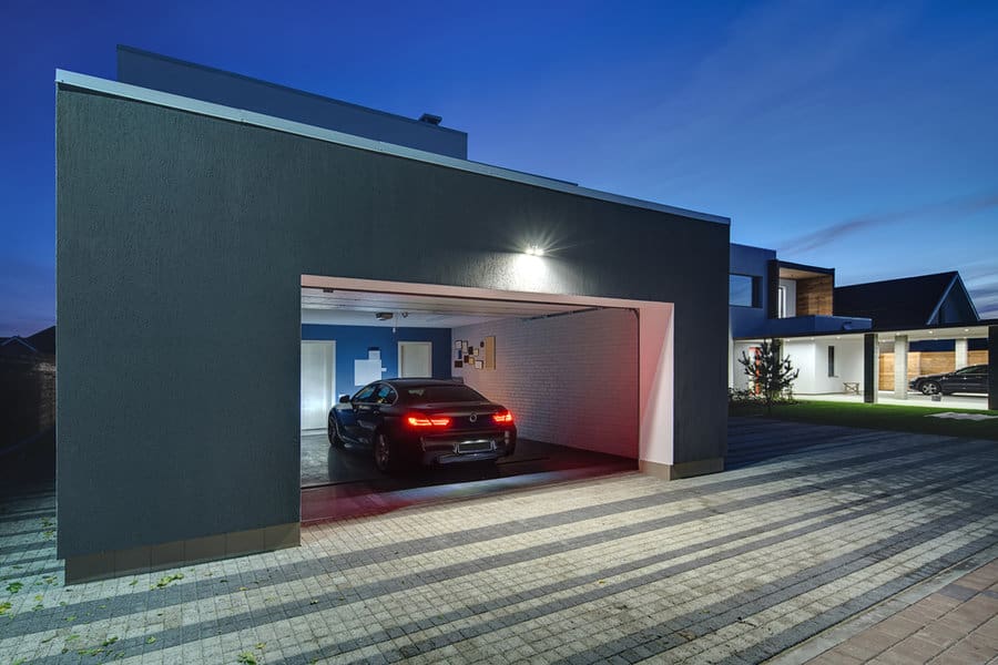 Car parked in an open garage with overhead lighting