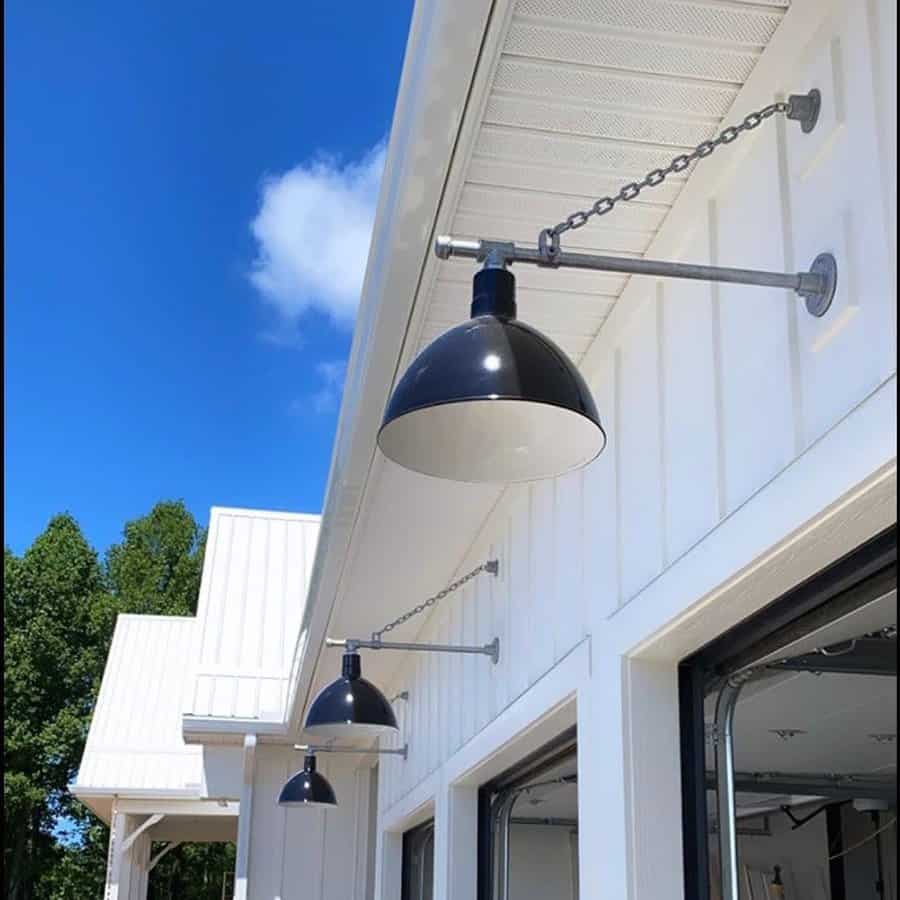 Outdoor pendant lights on a white building facade