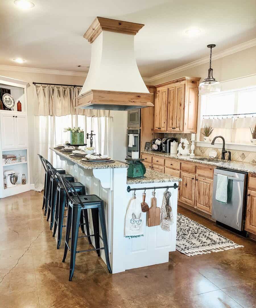 Rustic farmhouse breakfast bar with a white shiplap island, natural wood cabinetry, granite countertops, and black metal barstools for a cozy feel