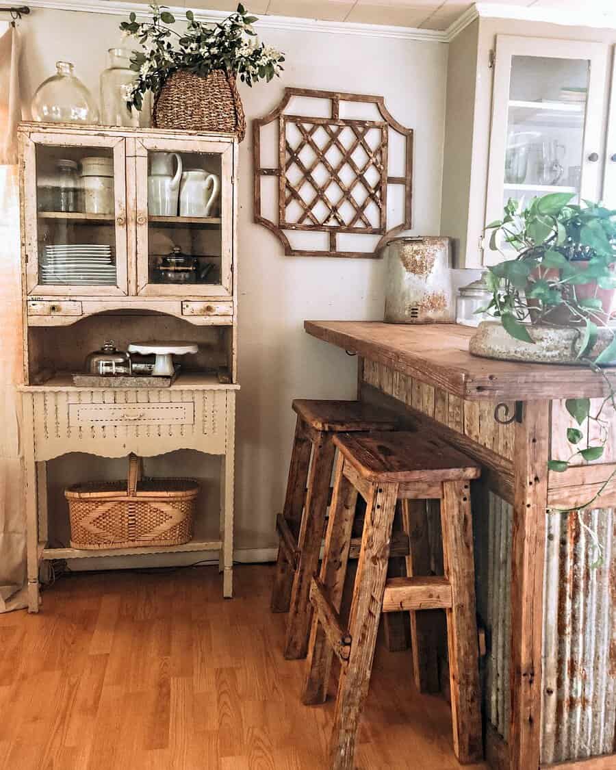 Rustic farmhouse breakfast bar with a weathered wood countertop, corrugated metal base, wooden barstools, and vintage decor for a cozy charm