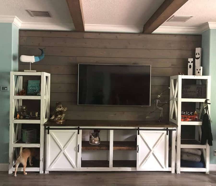 Modern farmhouse TV wall with decorative shelves and beams