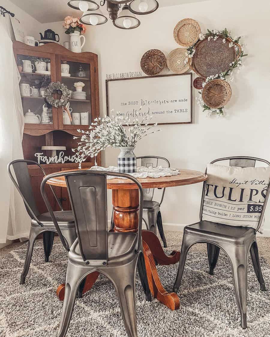 Cozy farmhouse dining room with a wooden table, metal chairs, wicker wall decor, and a cabinet filled with dishes and mugs