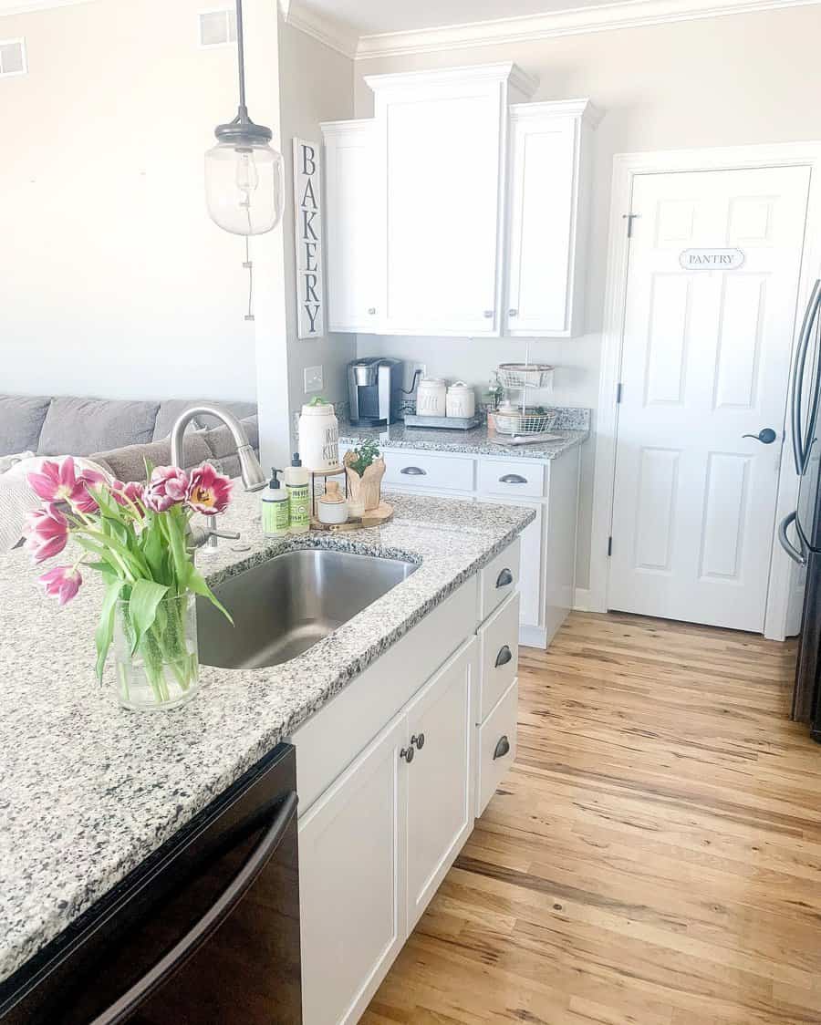 white kitchen with wooden flooring