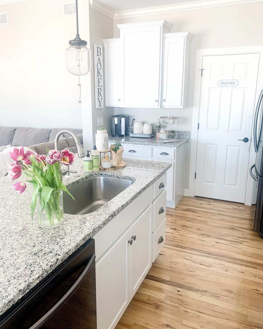 White kitchen with wooden flooring