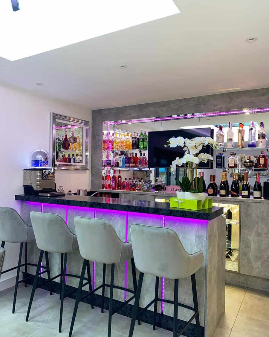 Modern bar with velvet stools and vibrant backlighting