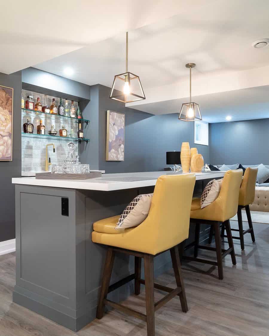 Chic basement bar with yellow stools and pendant lights