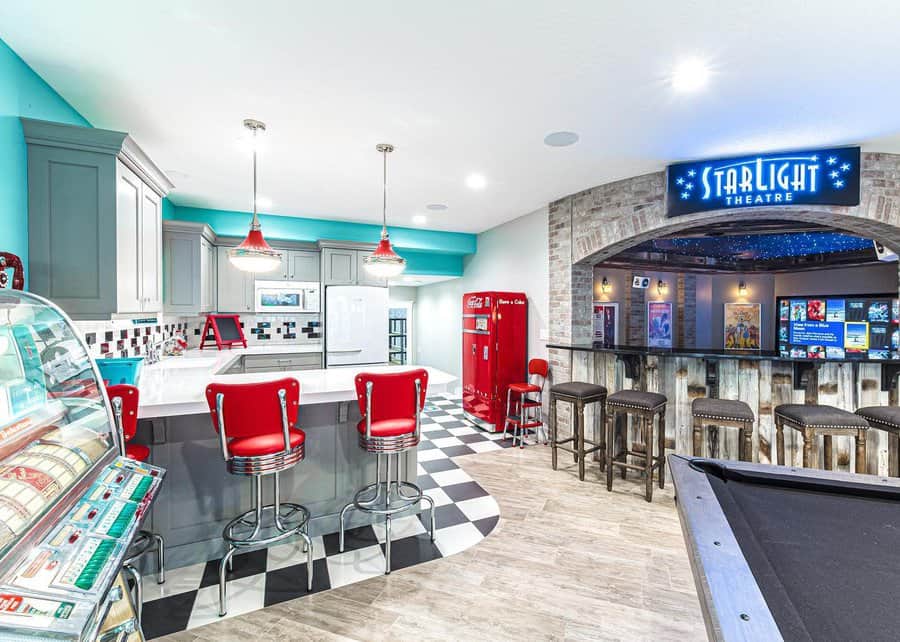 Retro diner style basement with a bar and theater entrance