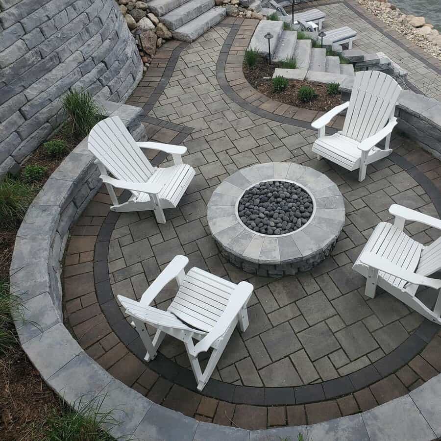 Patio with fire pit and white Adirondack chairs