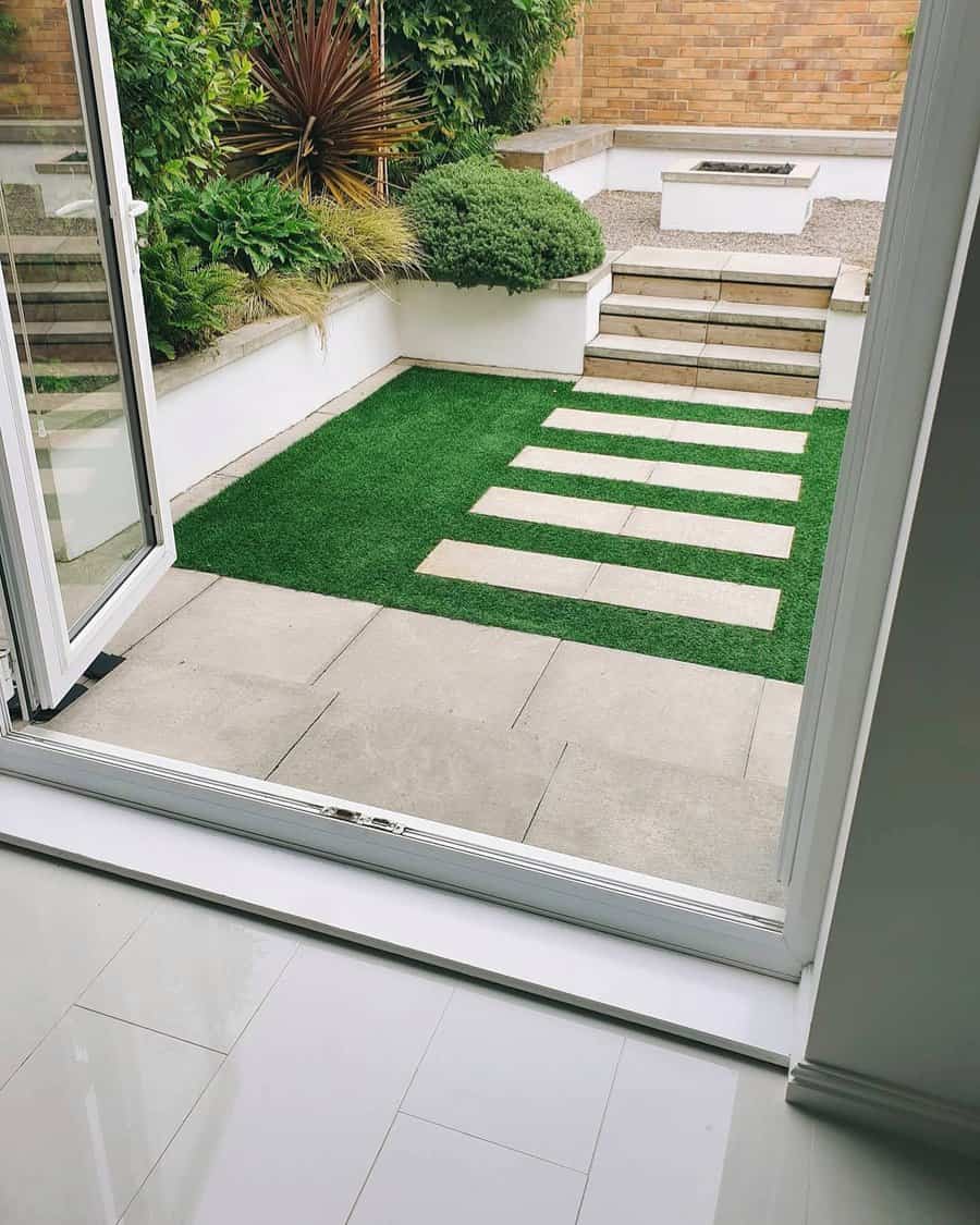 View of a tidy patio with stone slabs and lush plants