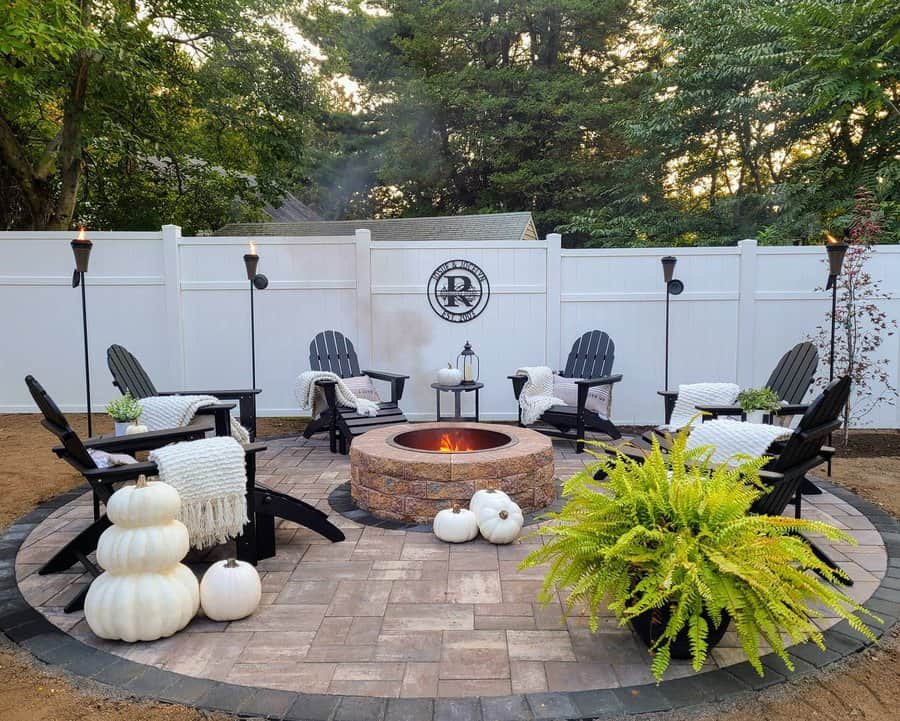 Cozy patio with fire pit and white fencing