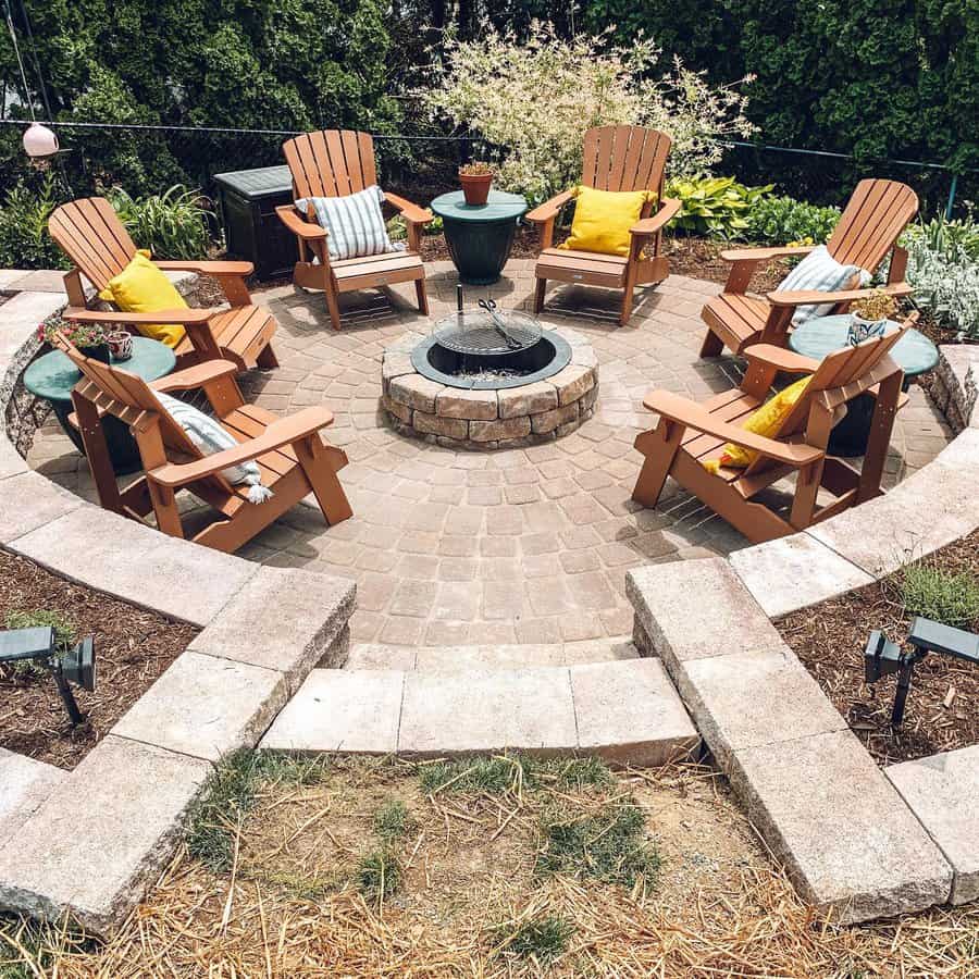 Patio with fire pit and surrounding Adirondack chairs