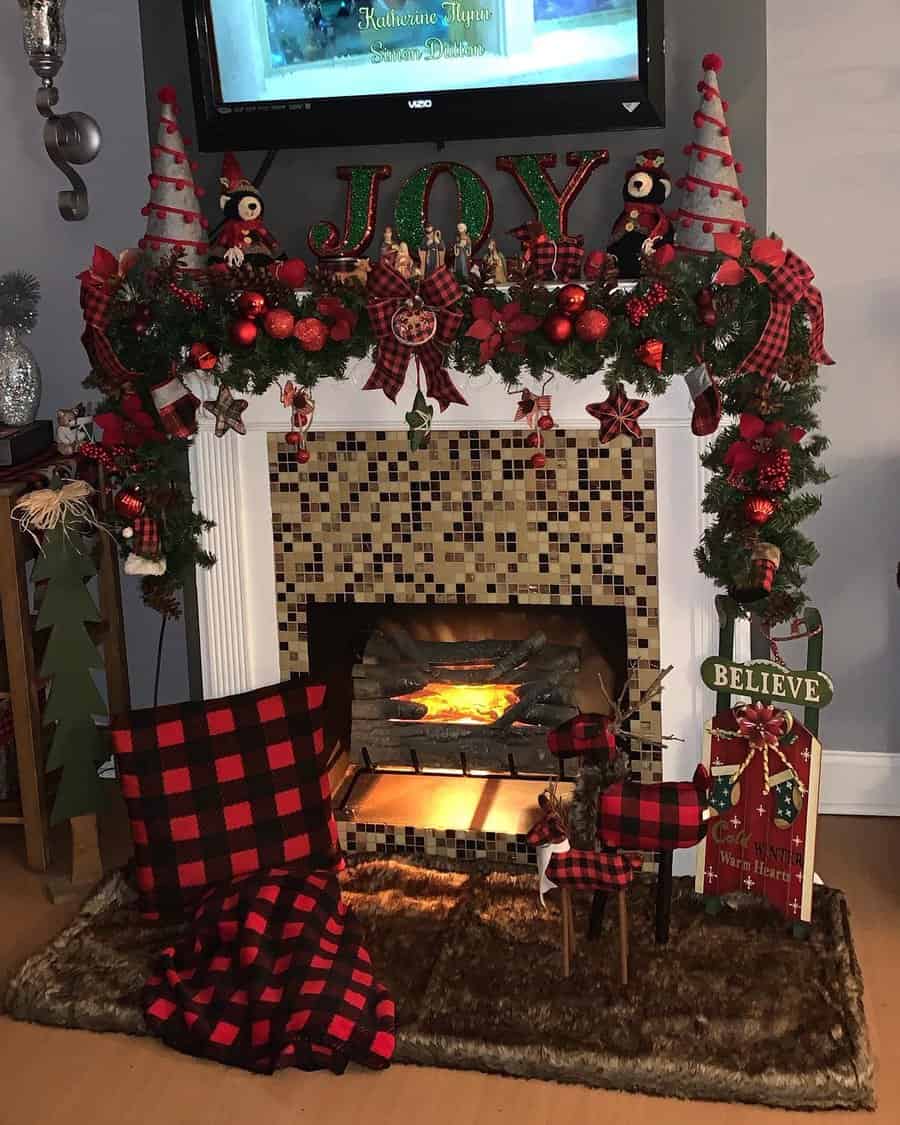 Festive Christmas fireplace adorned with garlands, plaid decor, and the word "JOY"