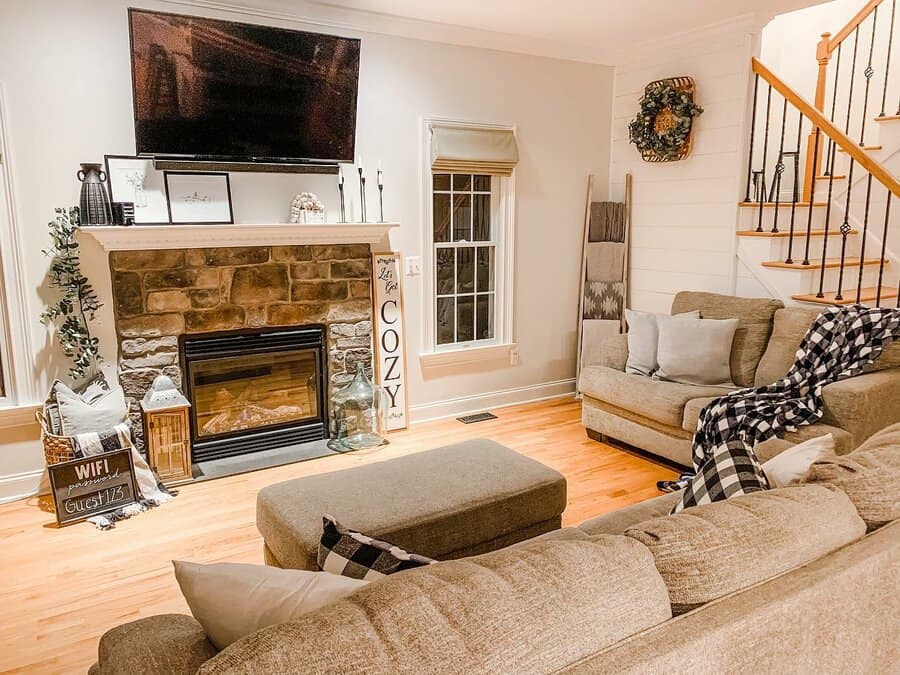 Homely living room with stone fireplace and staircase