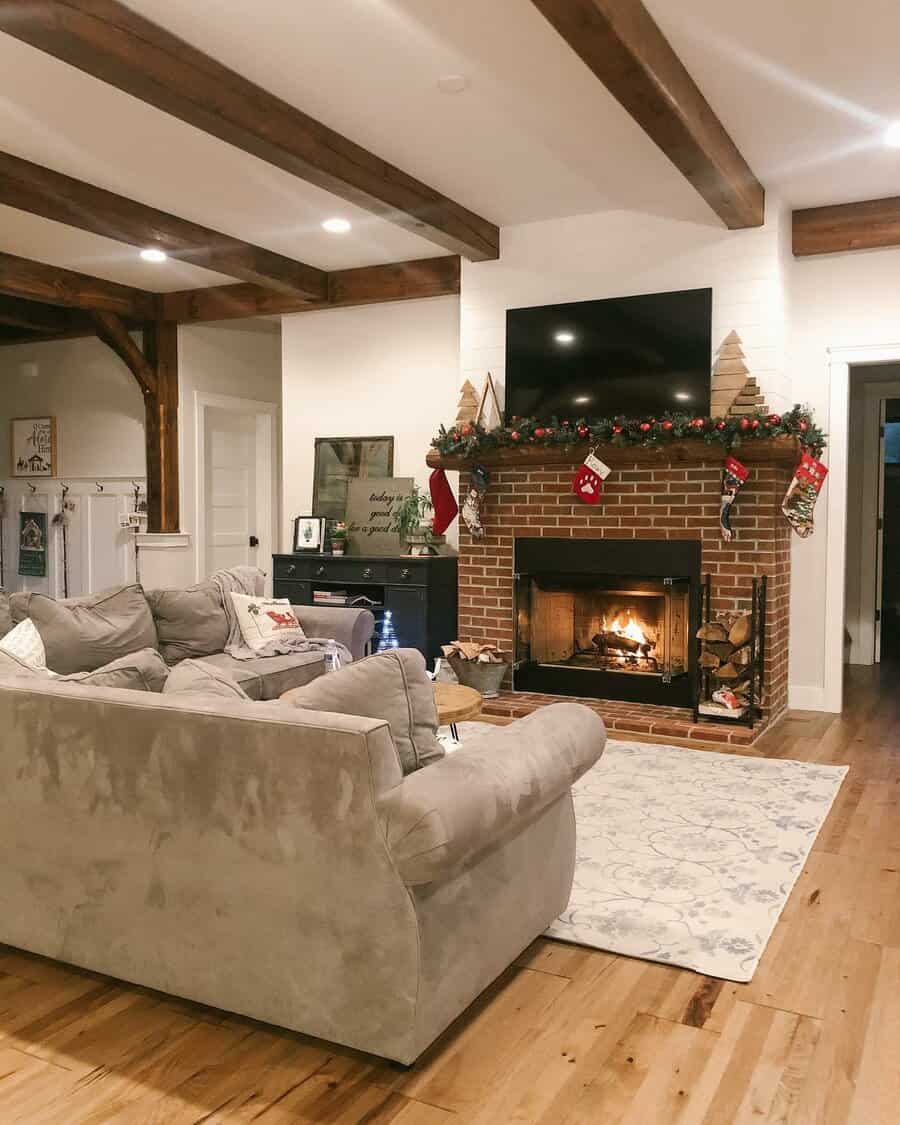 Festive living room with brick fireplace and holiday stockings