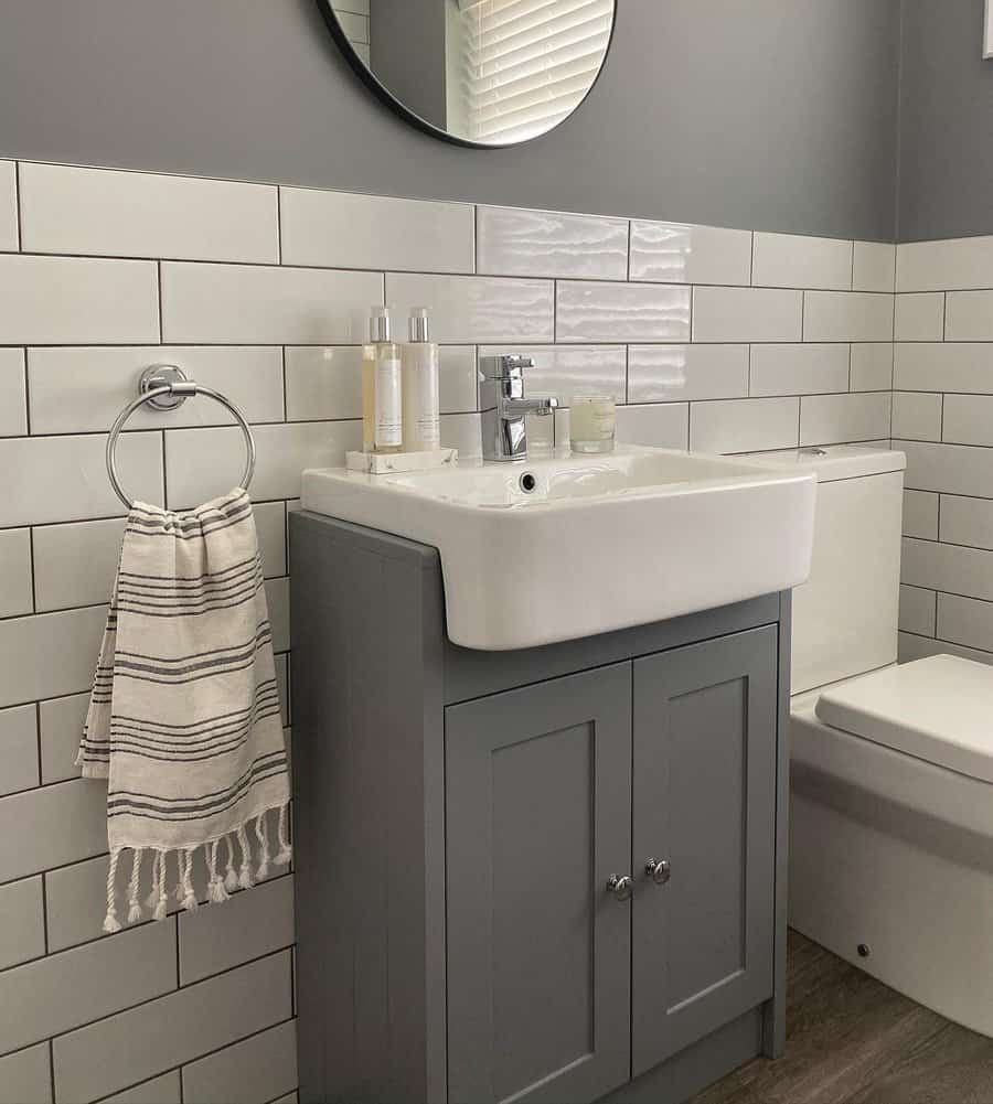 Subway tiled bathroom with gray vanity