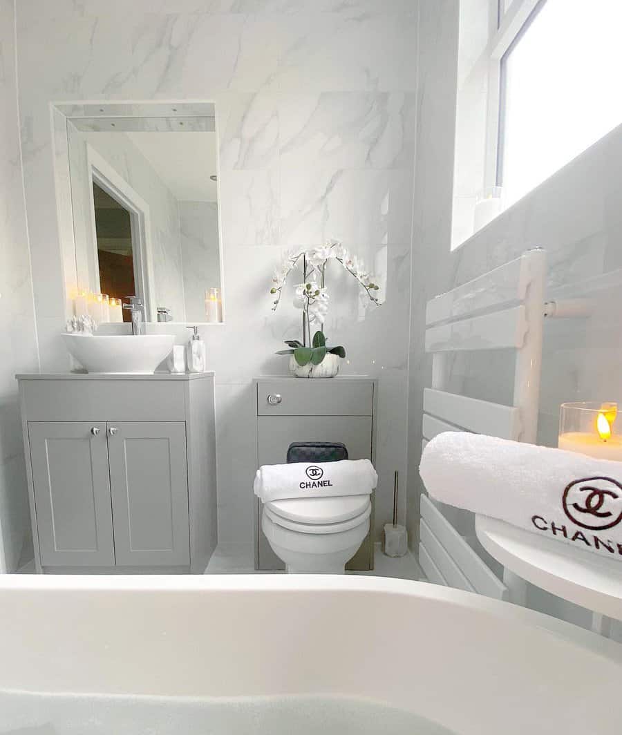 Elegant marble bathroom with gray vanity