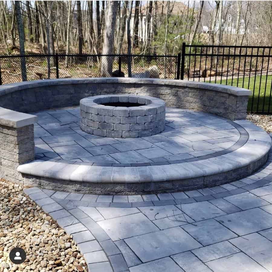 Circular stone patio with built in fire pit and bench