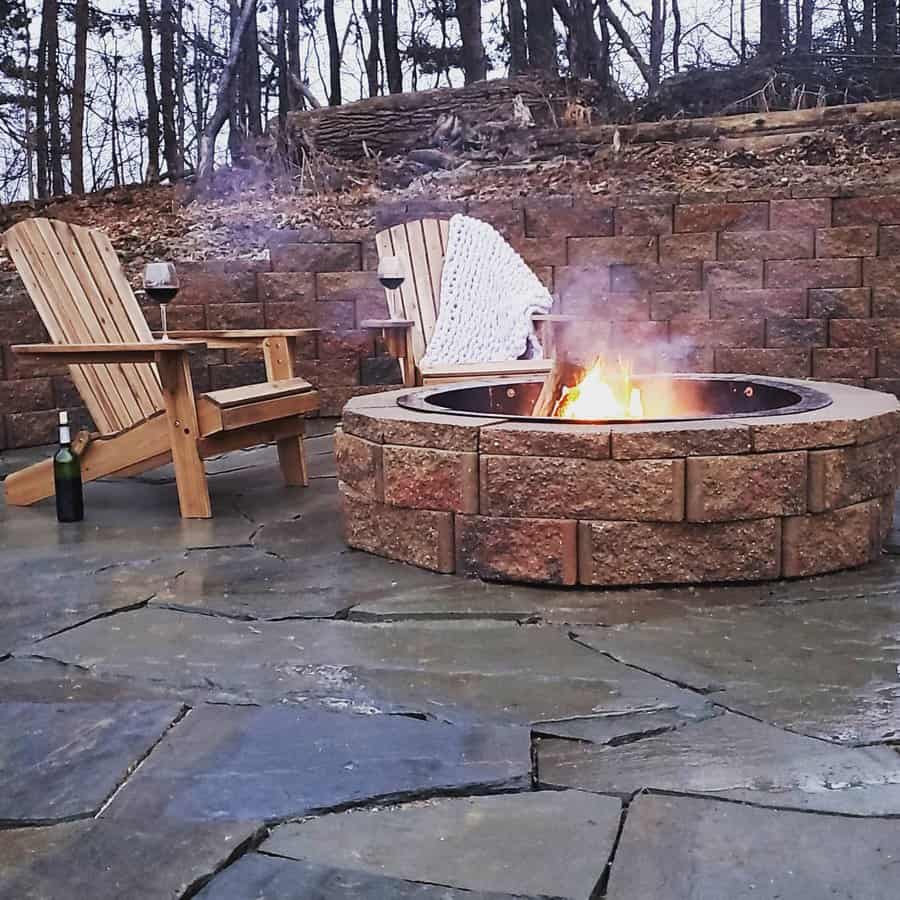 Cozy fire pit with Adirondack chairs on flagstone patio