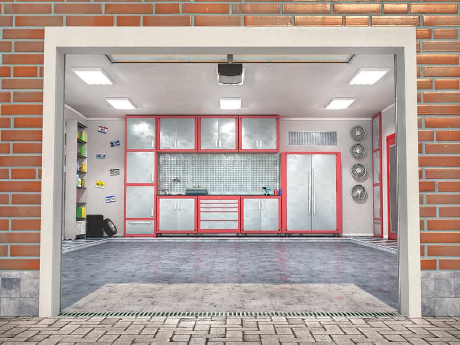 Well lit garage with red cabinets and tiled walls