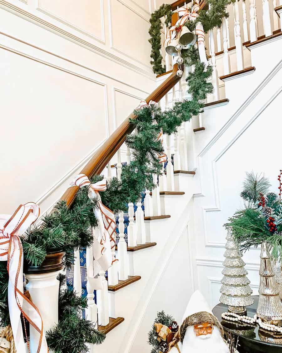 Festive staircase decorated with garland, ribbons, and holiday ornaments