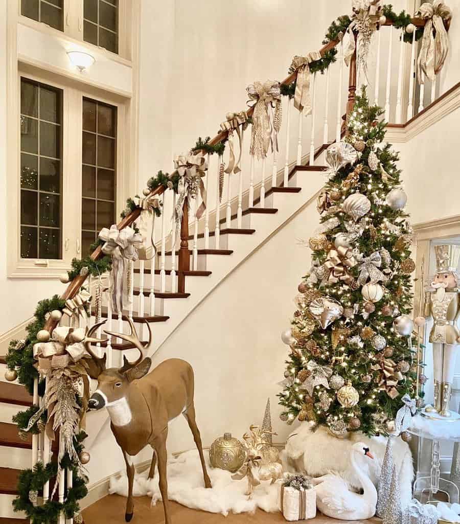 Christmas-decorated staircase with a tree, reindeer figure, and festive ornaments