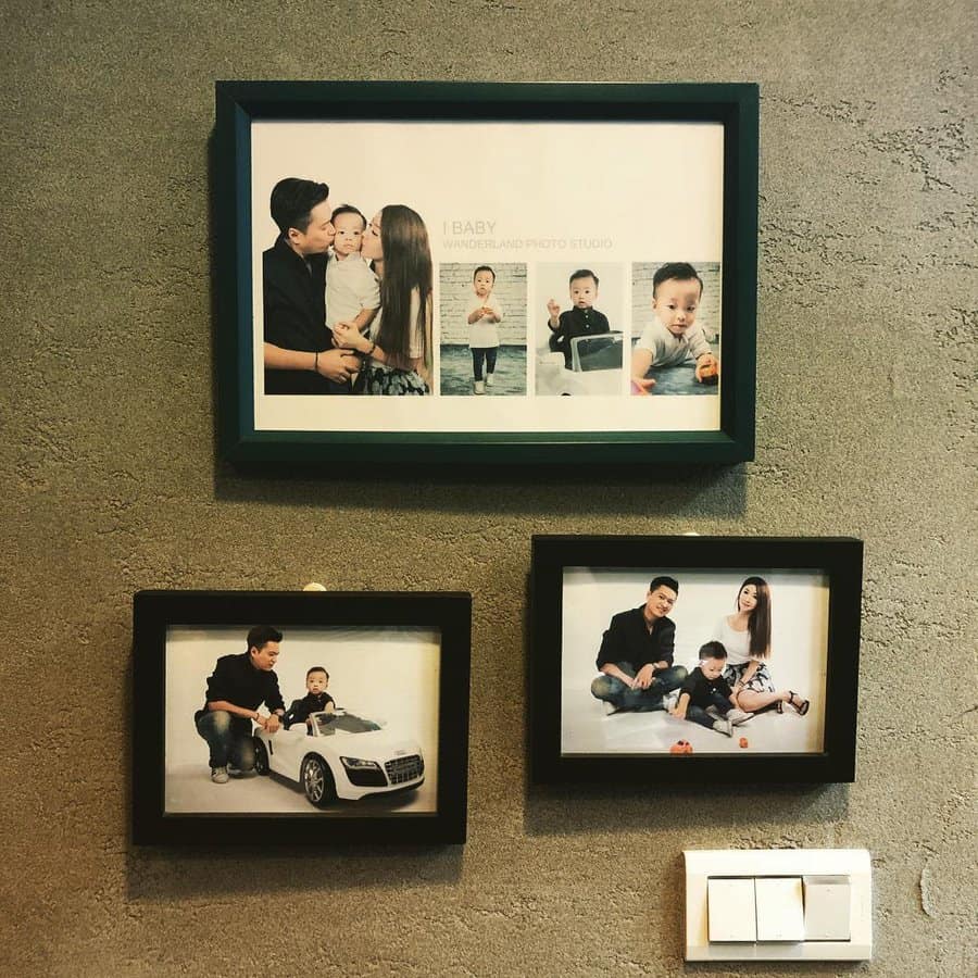 Three framed family photos on a wall featuring parents with a child, playing and posing with a toy car