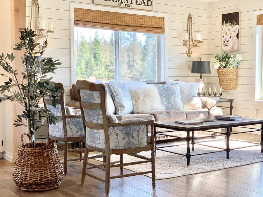 Bright country living room with large window and soft decor