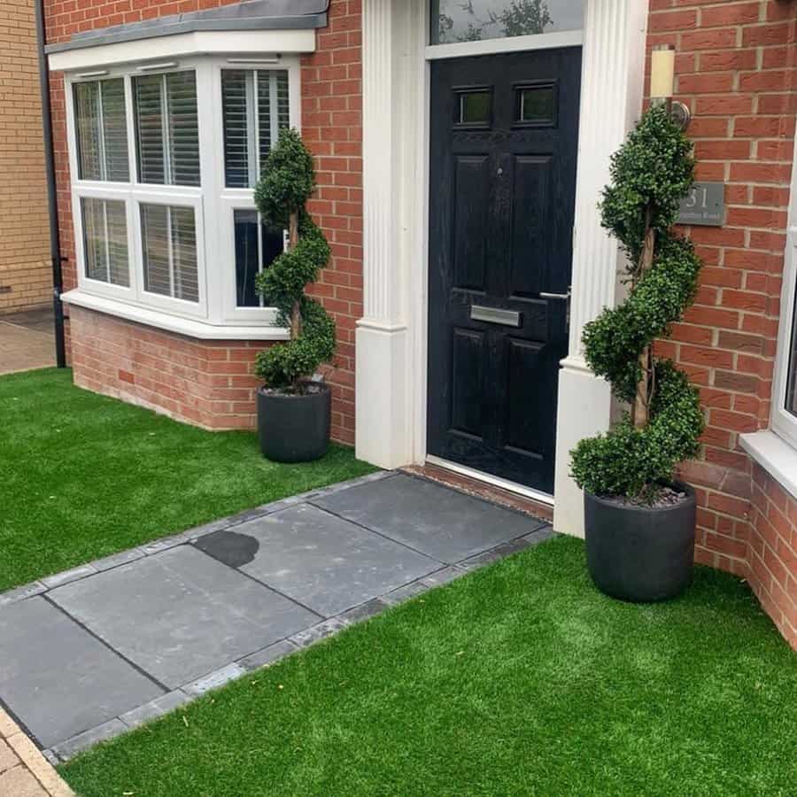 Front garden with potted plants on the doorway