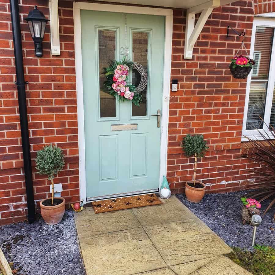 Front garden with potted plants on the doorway