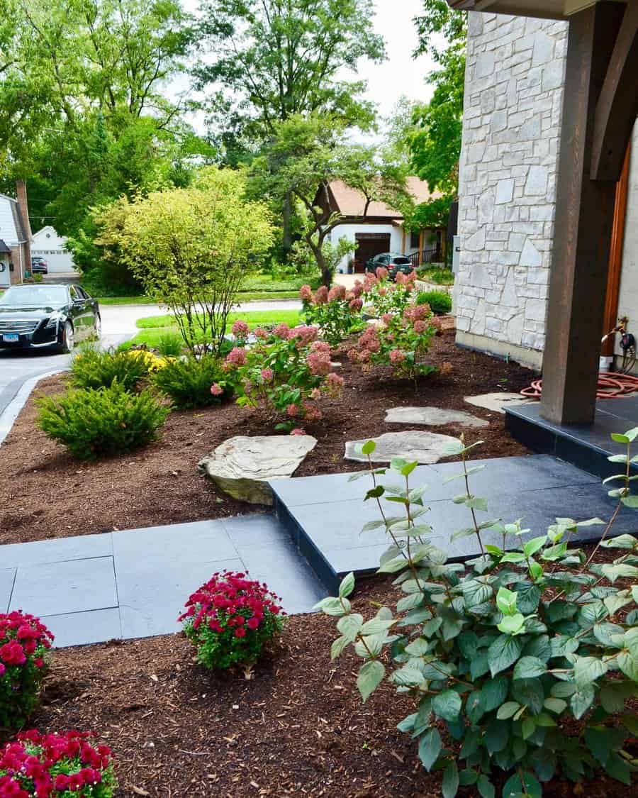 Vibrant garden with stone path and driveway