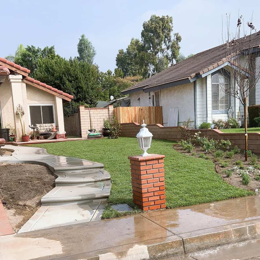 Residential front yard with fresh lawn and pathway lantern