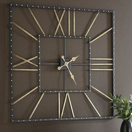 A square wall clock with Roman numerals