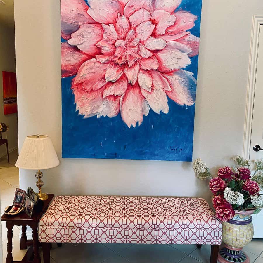 Vibrant entryway with a patterned bench, bold floral artwork, and elegant decor, creating a stylish and welcoming focal point