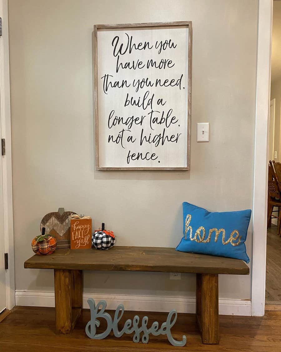 Rustic entryway with a wooden bench, cozy fall decor, a heartfelt quote sign, and a "Blessed" accent, creating a warm and welcoming space