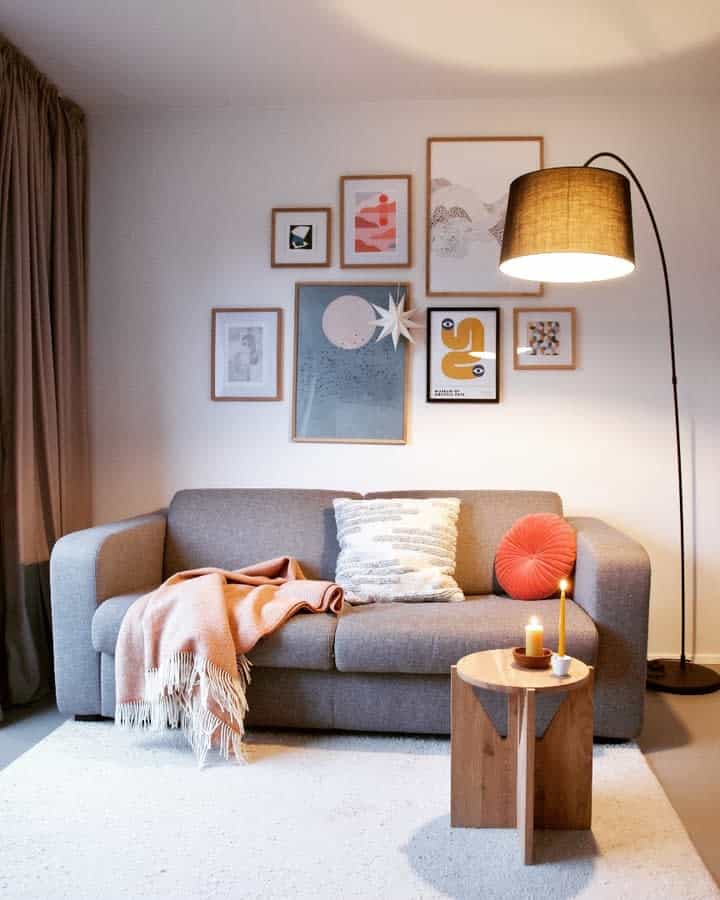 Warm living area with gallery wall and floor lamp