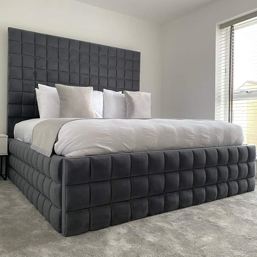 Stylish bedroom with tufted grey headboard