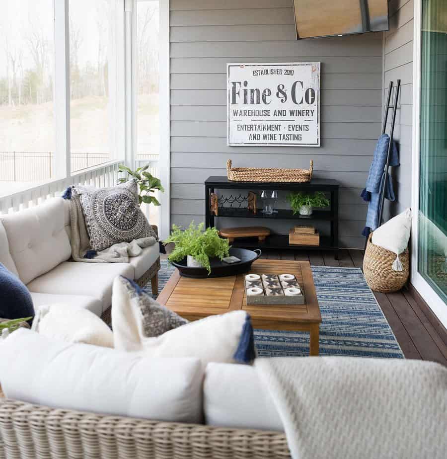 Cozy patio with woven furniture, blue accents, and a wooden coffee table