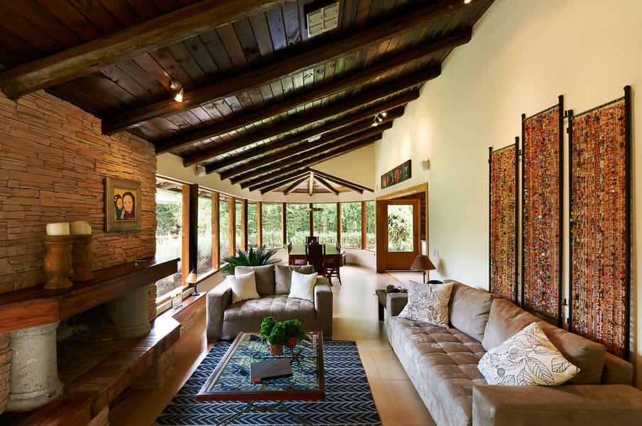 Spacious rustic living room with exposed beams and large windows