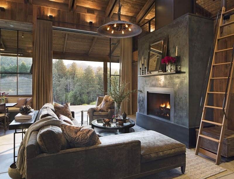 Luxurious cabin style living room with forest view and modern fireplace