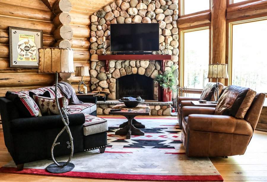 Cozy log cabin living room with stone fireplace and wood accents